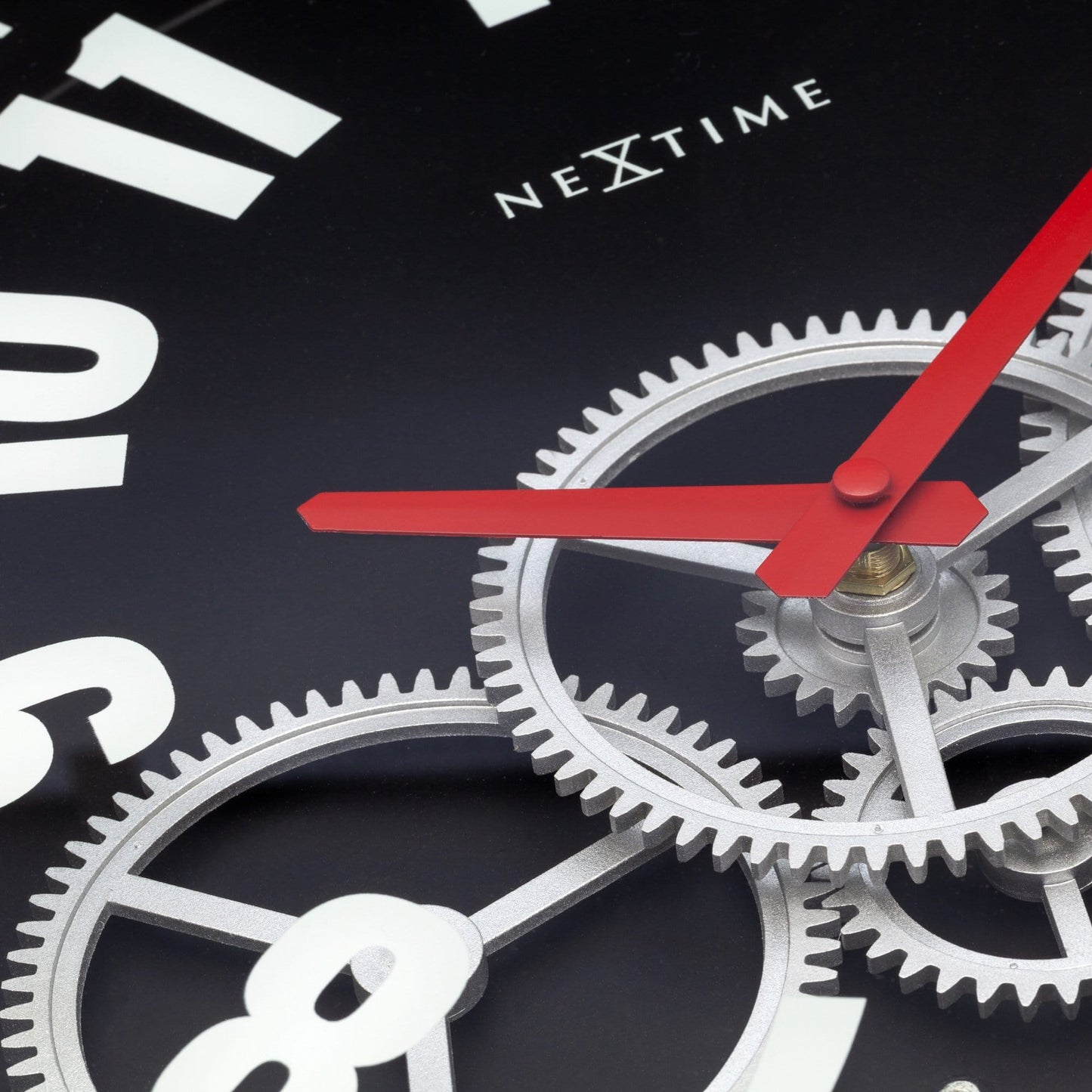 Close-up of NeXtime Modern Gear Clock showing moving gears, 36cm metal and glass wall clock with intricate gear details.