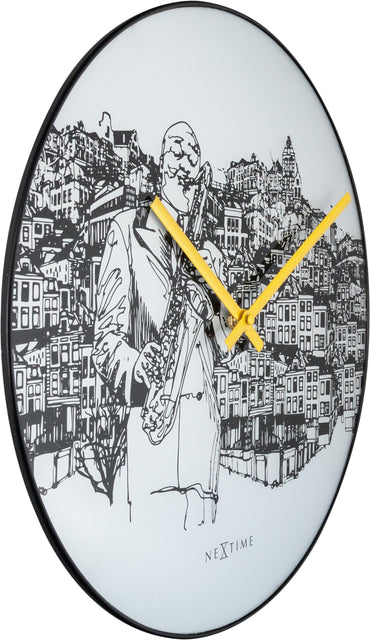 NeXtime Clocks Sax City wall clock, 40cm with glass and metal frame, showing a modern design on a white wall.