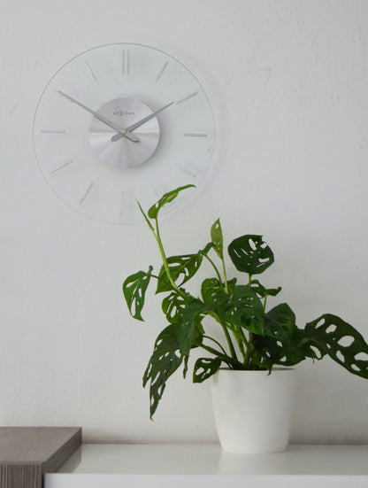 NeXtime Clocks 26cm aluminum and glass wall clock with a stylish stripe design.