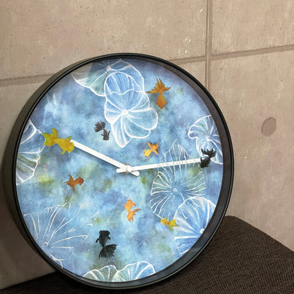 Blue plastic NeXtime wall clock, 30cm silent clock with pond design, perfect for modern home decor.