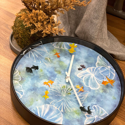 Blue NeXtime Clocks wall clock, 30cm silent plastic clock with pond design, perfect for modern home decor.