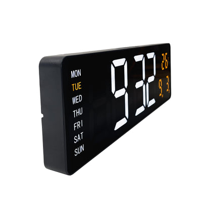 Black NeXtime Super Digi digital wall clock showing time on a large LED display, measuring 38.8x12.9x3.2cm, mounted on the wall.
