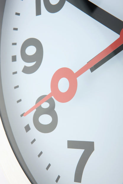 NeXtime Clocks aluminum wall or table clock with station number design, featuring a sleek modern look and clear time display.