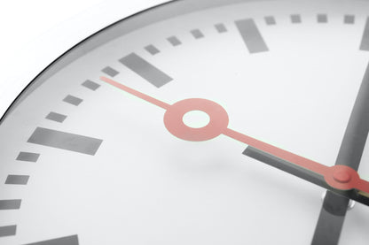 NeXtime Clocks Station Stripe aluminum wall or table clock with modern design and black and white striped face.