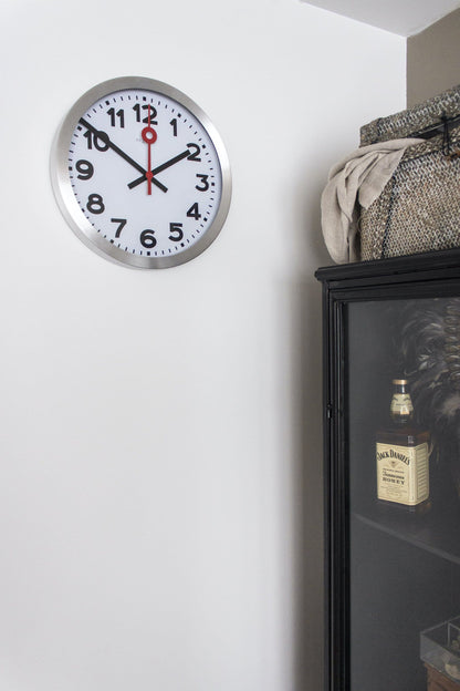 NeXtime Clocks aluminum wall or table clock with a modern design featuring station number graphics.
