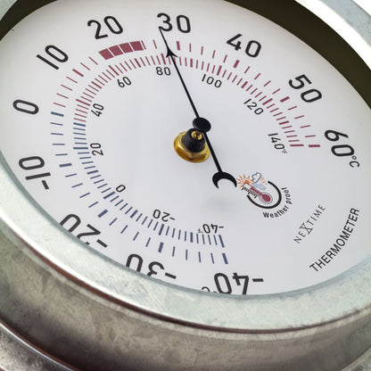 Weatherproof garden thermometer by NeXtime Clocks, 22cm galvanized metal design with Lily pattern, suitable for outdoor use.