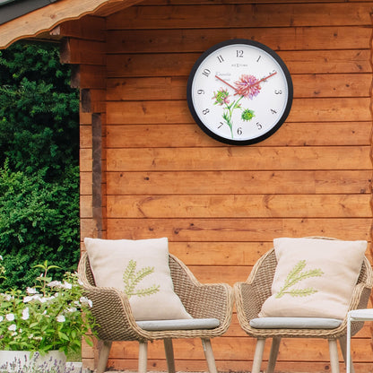Weatherproof outdoor garden clock by NeXtime Clocks, 30.5 cm diameter, with a stylish Knautia design and clear time display.