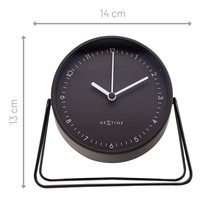 NeXtime Clocks Berlin table alarm clock with silent metal design, measuring 14x13x7cm, on a neutral surface.