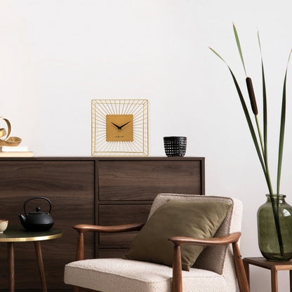 NeXtime Vasco table or wall clock in gold with a sleek metal design, measuring 25x25x12cm, featuring a silent mechanism.