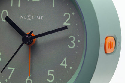 NeXtime Circle alarm clock with silent light dial, 10.5cm x 3.6cm, featuring a sleek round design and clear time display.