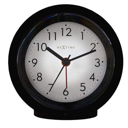 NeXtime Circle alarm clock with silent light dial, 10.5cm by 3.6cm, modern design, front view showing clock face and features.