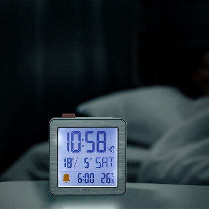 Mini digital table alarm clock by NeXtime with metal and ABS construction, featuring a compact 6x6.4x2.1cm design.