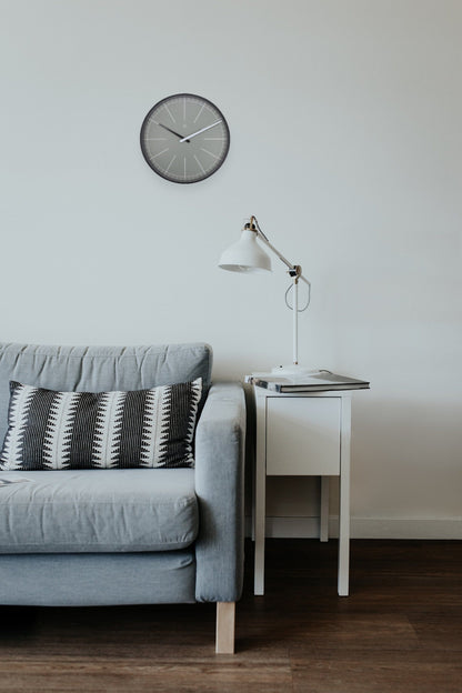 Gray plastic wall clock by NeXtime Clocks, 40 cm diameter, featuring a modern design with clear hour markers and sleek hands.
