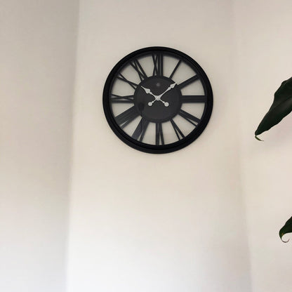 NeXtime Clocks Quebec wall clock, 51 cm plastic with a modern design, displayed on a wall.