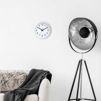 NeXtime Clocks wall clock, 25.5cm, silent plastic design with robust style, shown in a modern home setting.