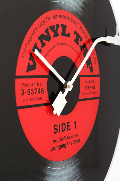 NeXtime Clocks Vinyl Tap wall clock, 43 cm diameter with glass face, featuring a vinyl record design.