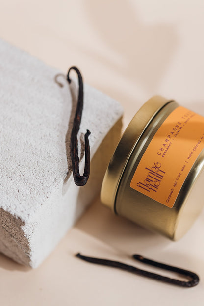 Flambé Fleuri Champagne Toast candle in a decorative tin, featuring a elegant design for celebratory ambiance.
