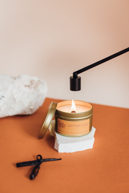 Flambé Fleuri Champagne Toast candle in a decorative tin with a festive, elegant design and a warm, inviting glow.
